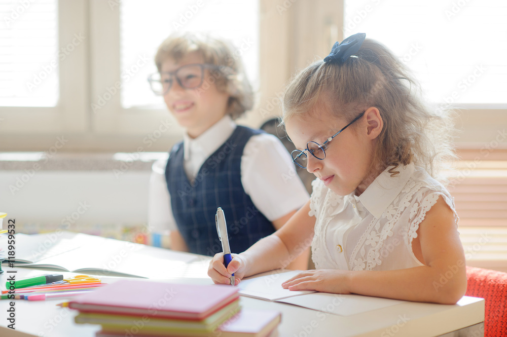 Small schoolkids in the lesson. Small schoolkids in the lesson.