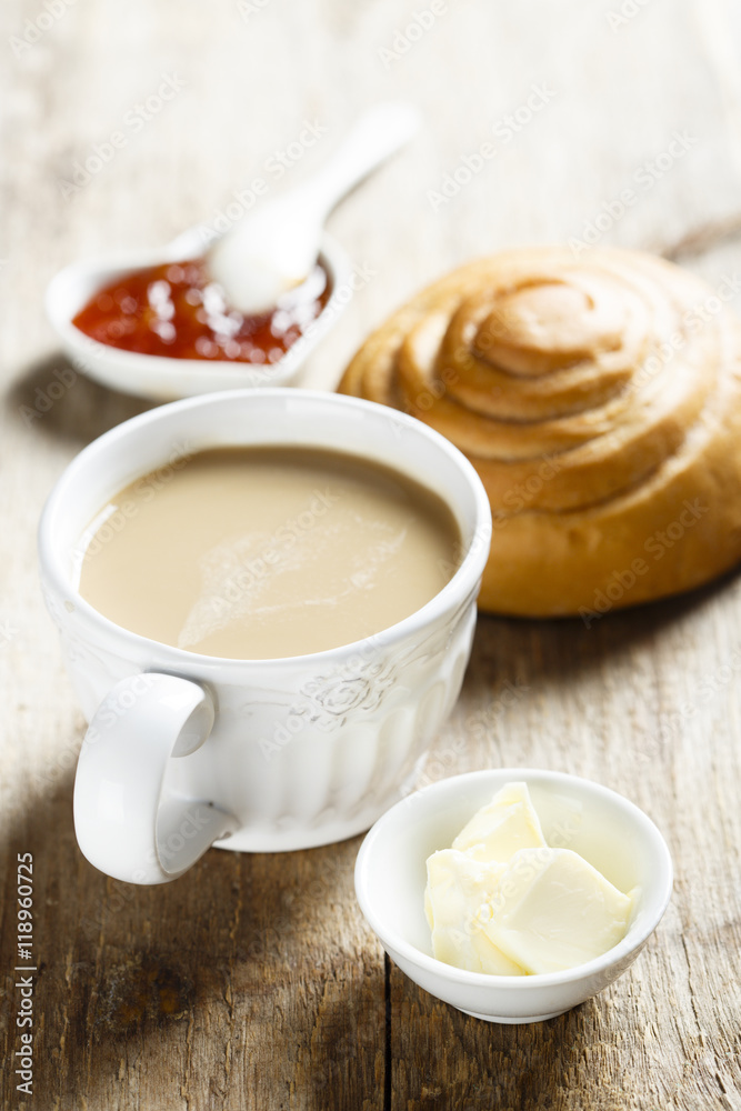 Breakfast table, served with coffee, jam and fresh bun Breakfast table, served with coffee, jam and fresh bun