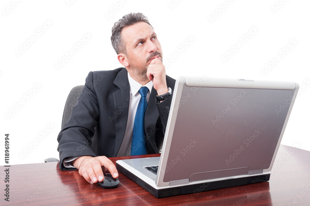 Serious broker thinking while sitting on office Serious broker thinking while sitting on office