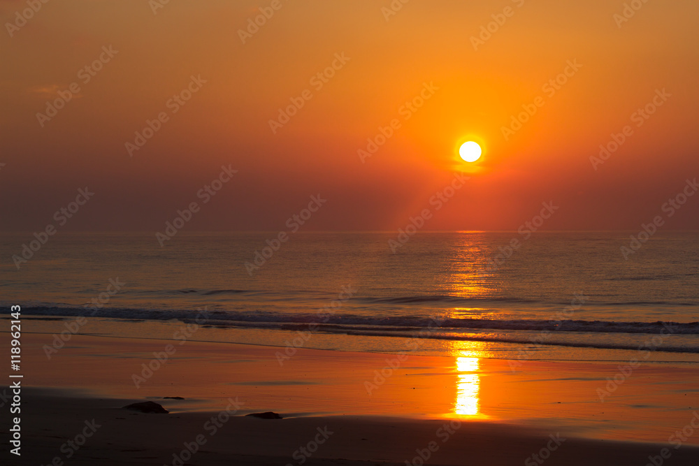 Pink sunset in ocean. India, Andaman island. Beach with wave
