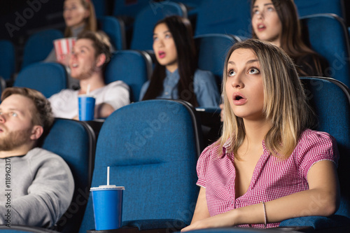 Unexpected turn! Shot of an attractive female looking shocked watching a movie at the cinema