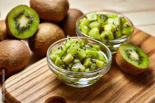 Healthy food. Tropical fruit. Whole and sliced kiwi. Kiwi fruit. Still life. Juicy kiwi on the wooden table