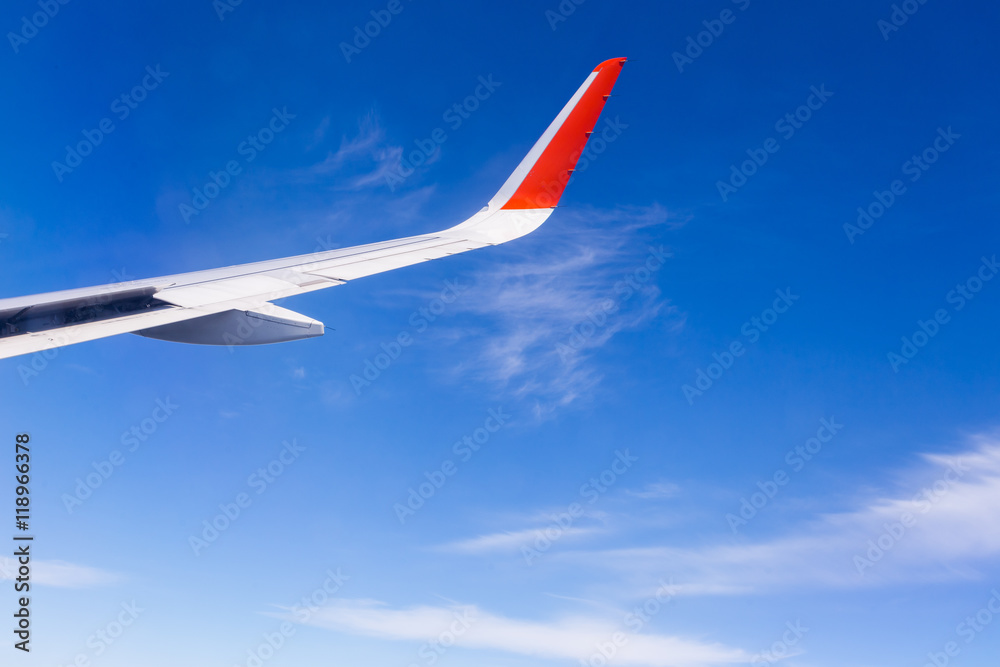 Fototapeta premium View from airplane window with blue sky and white clouds