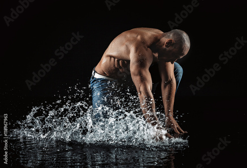  athletic man striking with a hand on water