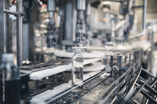 Robotic factory line for processing and bottling pure spring water into used gallons. Short depth of field and selective focus.