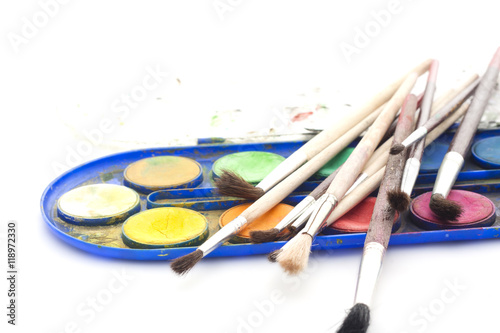 Set of watercolor paints with brushes on white background