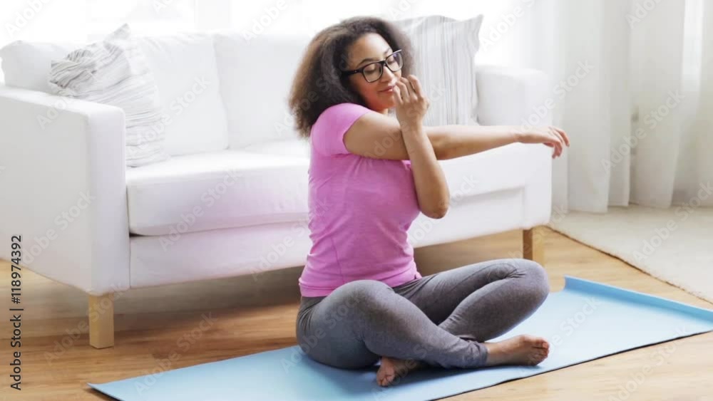 happy african woman exercising on mat at home happy african woman exercising on mat at home