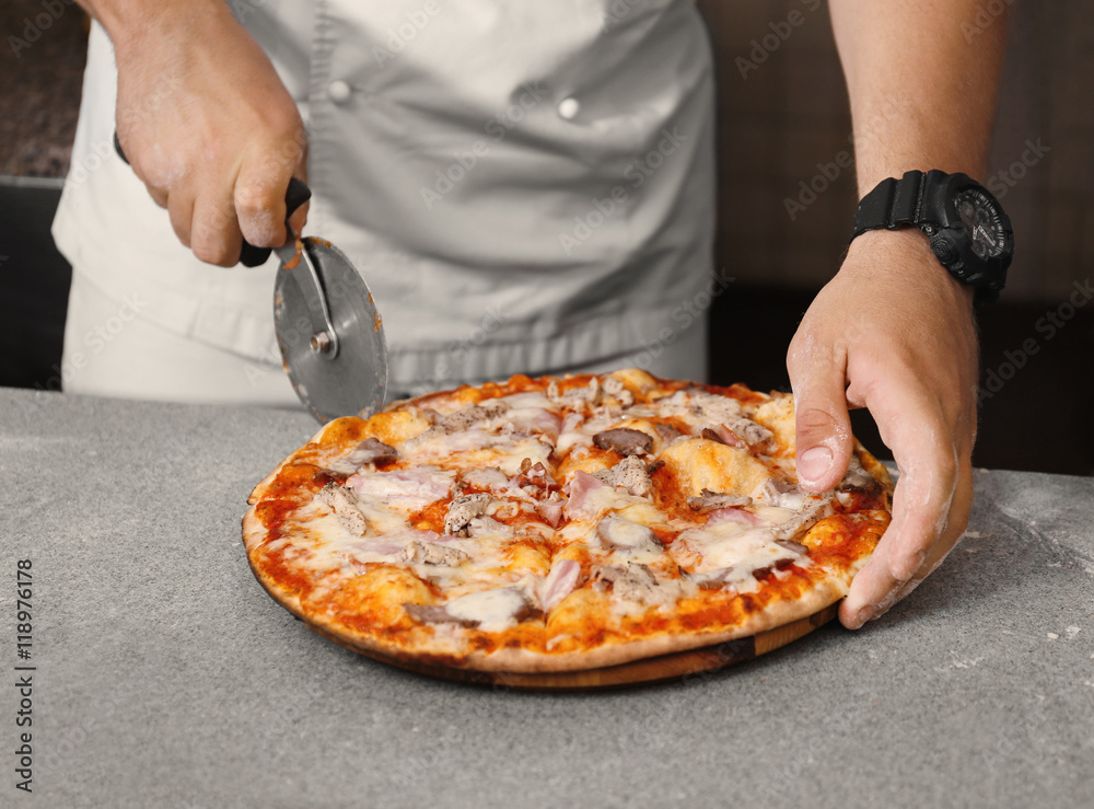 Cook preparing pizza