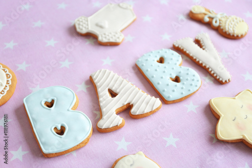 Baby glazed cookies on decorated table