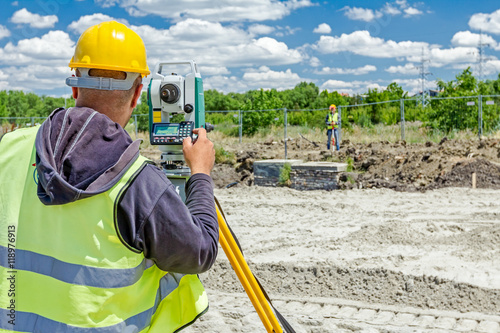 Geodesist is working with total station on a building site. Civi photo
