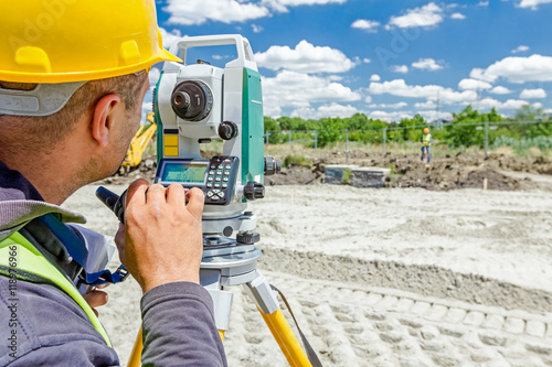 Zrenjanin, Vojvodina, Serbia - June 22, 2015: Surveyor engineer is measuring level on construction site. Geodesist is working with total station on a building site.