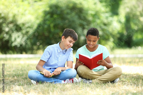 Cute boys reading books on ...
