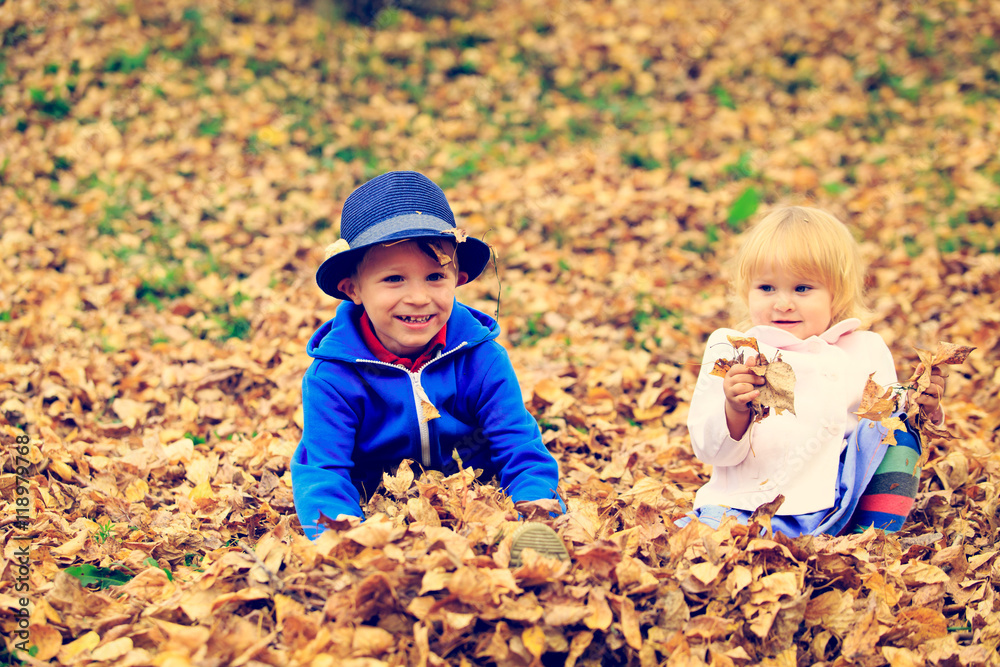 cute little boy and girl playing in autumn cute little boy and girl playing in autumn