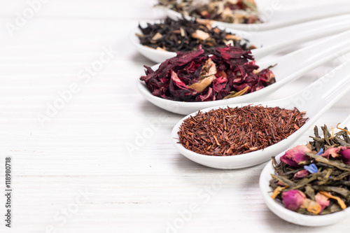 assortment of dry tea on a wooden table,healthy drink