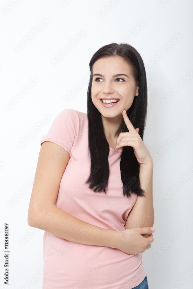 Portrait of an attractive young brunette woman ooking up dreaming. Portrait of an attractive young brunette woman ooking up dreaming.