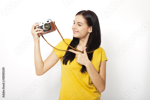 Young Woman Holding retrocamera against white background photo