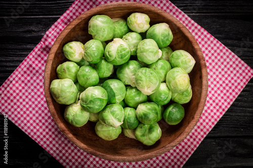 Fresh brussel sprouts over rustic wooden texture.healthy food