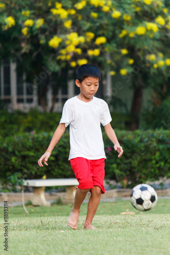 Thai boy playing soccer.