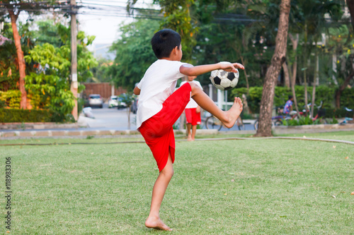 Fototapeta Naklejka Na Ścianę i Meble -  Thai boy playing soccer.