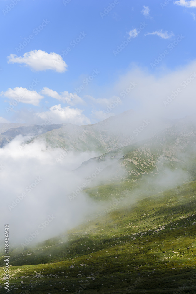 beautiful traditional plateau life and green nature on the mountains with fog