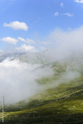beautiful traditional plateau life and green nature on the mountains with fog