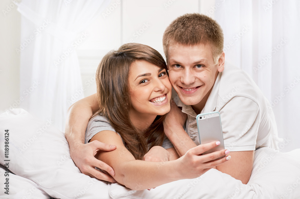 smiling portrait of Couple lying in bed