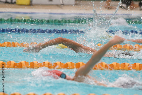 A group of swimmer swimming freestyle stroke in a swimming pool for competition or race