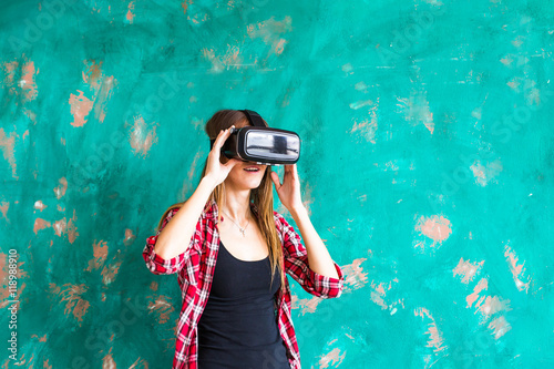 girl getting experience using VR-headset glasses of virtual reality gesticulating hands © satura_