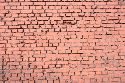 Old red brick wall as background horizontal view closeup