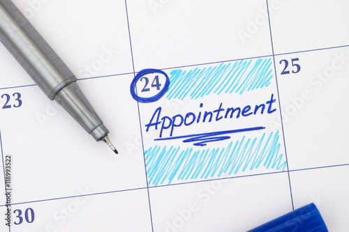 Reminder Appointment in calendar with blue pen photo