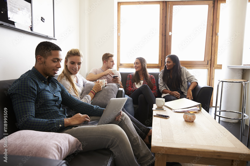 Students Relaxing In Lounge Of Shared Accommodation Students Relaxing In Lounge Of Shared Accommodation