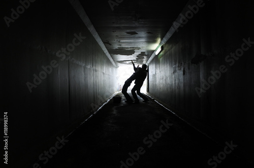 Man attacks a woman in a dark tunnel