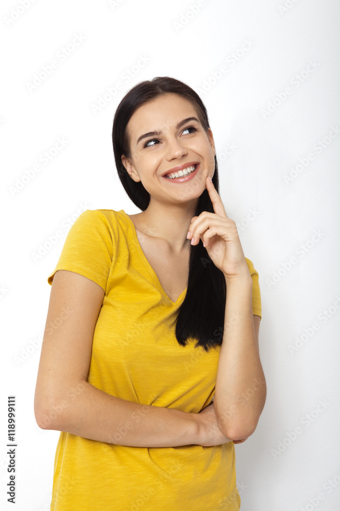 Portrait of an attractive young brunette woman ooking up dreaming. Portrait of an attractive young brunette woman ooking up dreaming.