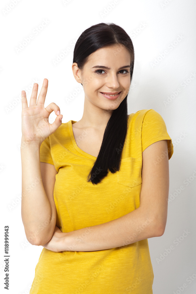 Happy young woman shows sign okay. Success. Isolated Happy young woman shows sign okay. Success. Isolated