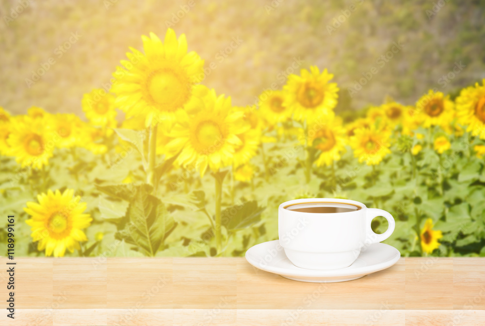 white cup coffee mug on wood desk and sunflowers background white cup coffee mug on wood desk and sunflowers background