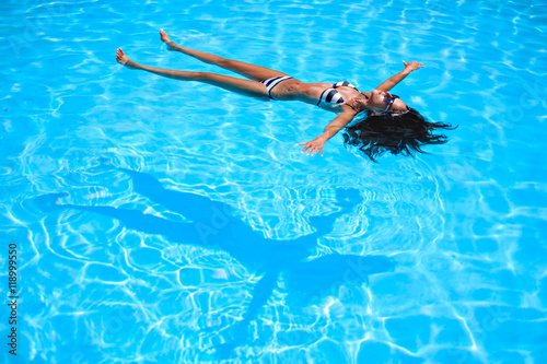 Girl floating in the pool