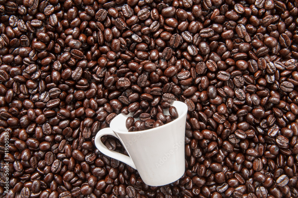 Coffee mug on coffee beans.