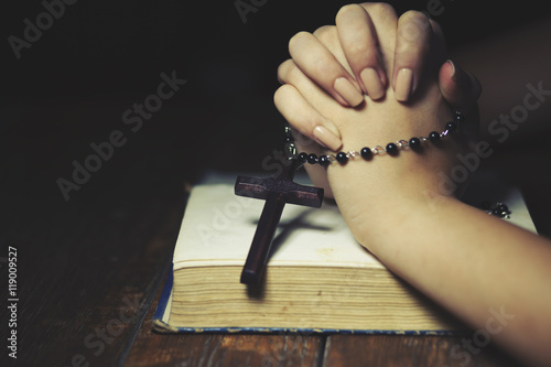 Praying woman holds cross