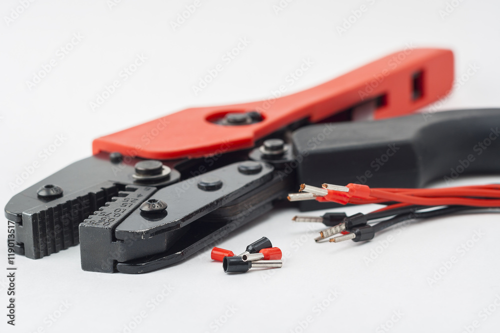 Isolated tool for crimping cable on a white background. Isolated tool for crimping cable on a white background.