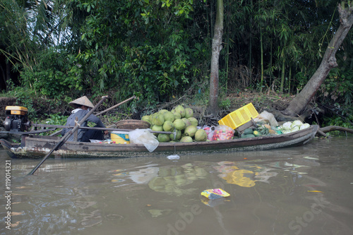 floating market on the Mekong river - boats with people selling watermelon 