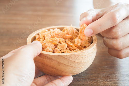 Fried shrimp chins snack in wooden bowl