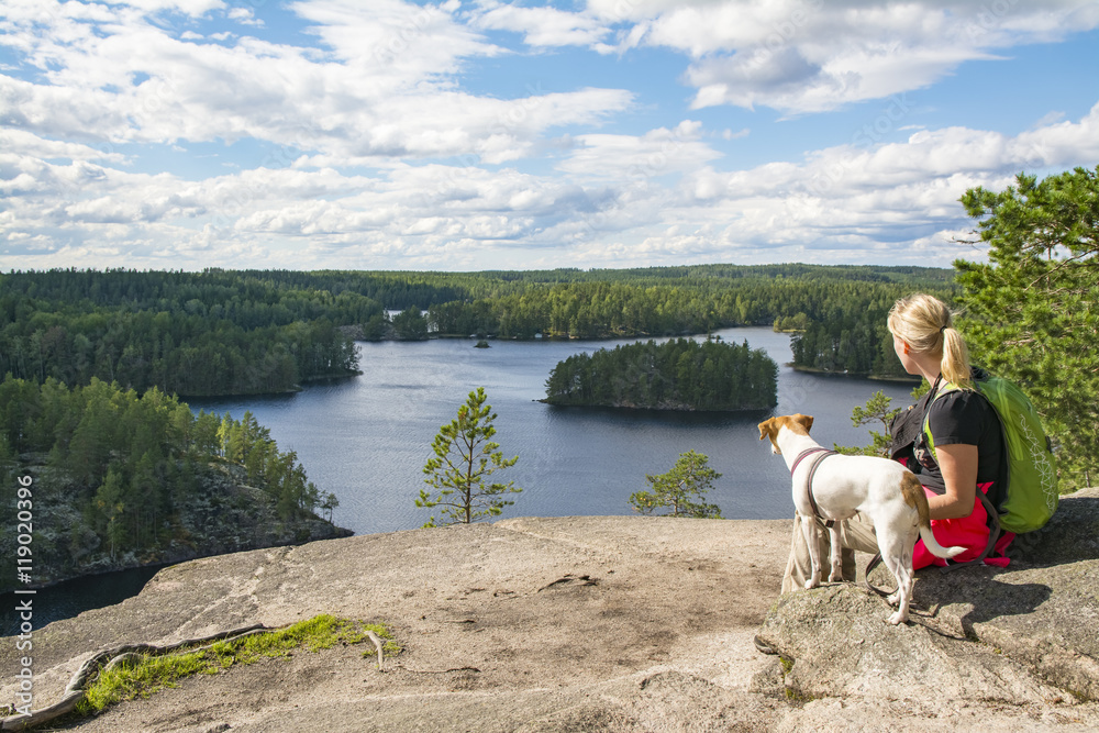 Obraz premium Woman hiking with dog in National Park in Finland