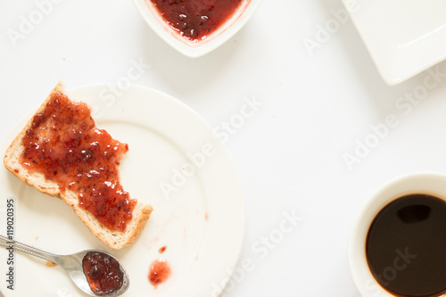 Bitten bread with strawberry jam