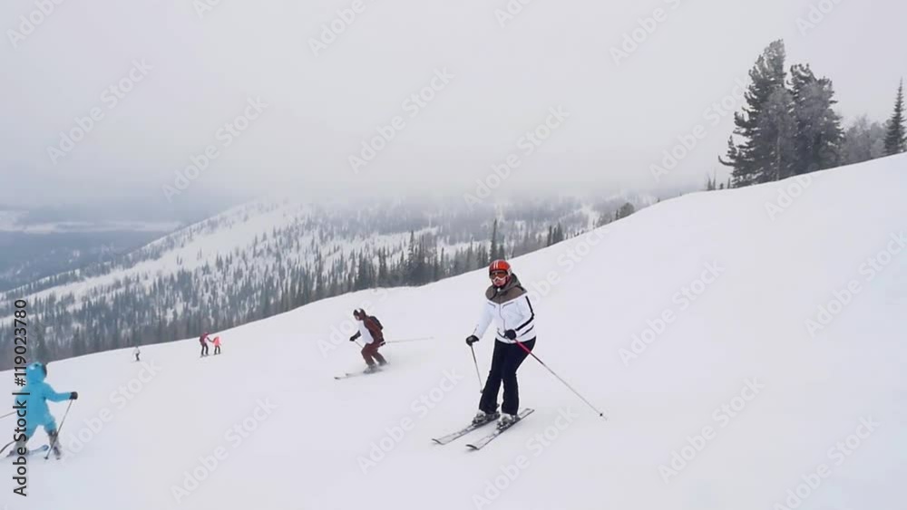 happy skiers and snowboarders on the slope at a ski resort in the Alps in slowmotion in a snowstorm. 1920x1080 happy skiers and snowboarders on the slope at a ski resort in the Alps in slowmotion in a snowstorm. 1920x1080