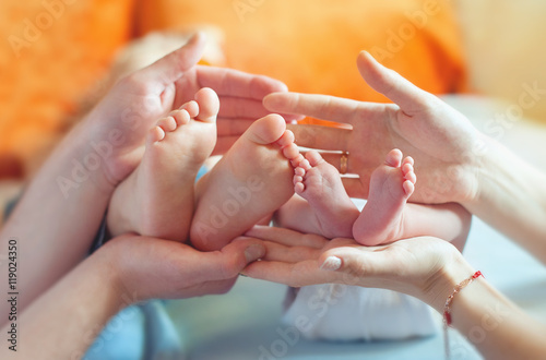 Children's feet in the hands of parents
