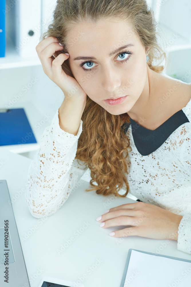 Top view of tired young secretary with laptop computer. Top view of tired young secretary with laptop computer.
