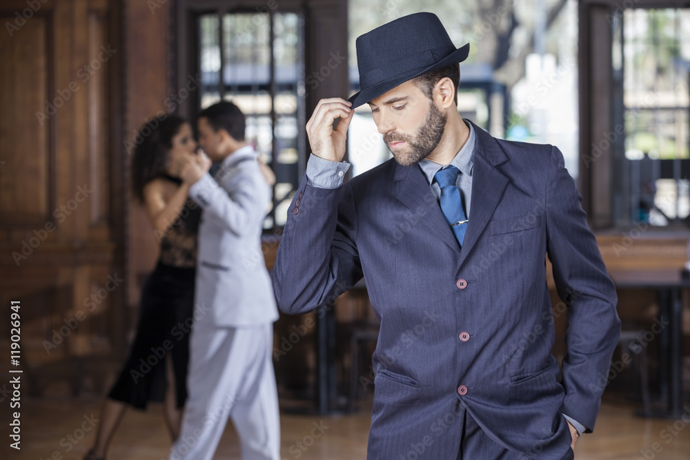 Tango Dancer Holding Hat While Partners Performing In Restaurant Tango Dancer Holding Hat While Partners Performing In Restaurant