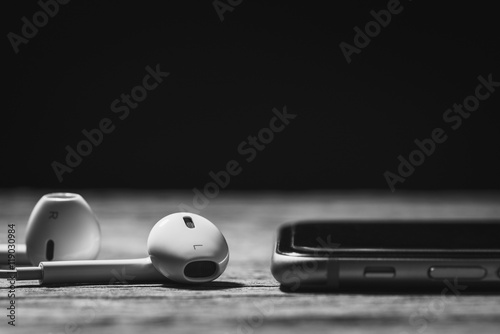 Headphone and phone media portable on dark tone.