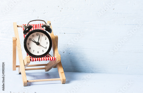 Alarm cloock on a sunbed. Holiday without cloock concept.Freedom