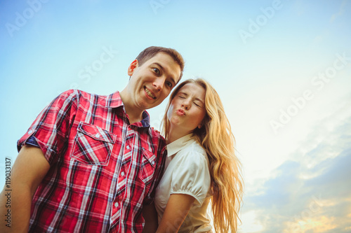 Look from below at pretty couple grimacing funny